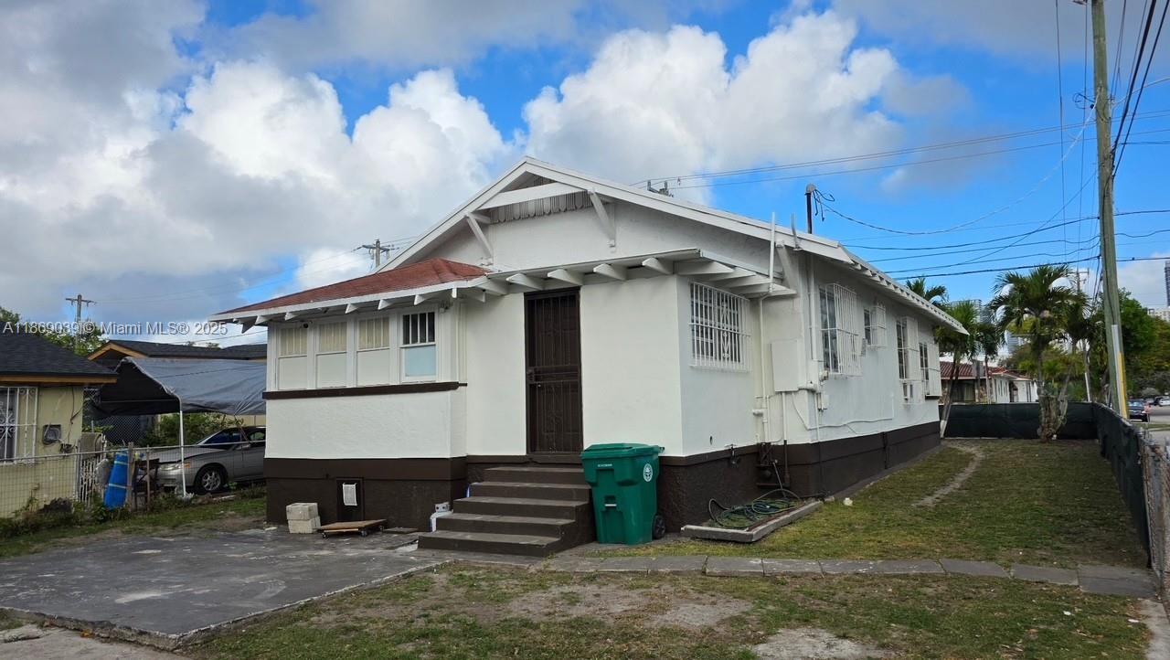 A white, single-story house with a brown base and a front porch sits on a lot — 844 SW 8th Ct, Miami FL 33130, MIAMI, FL