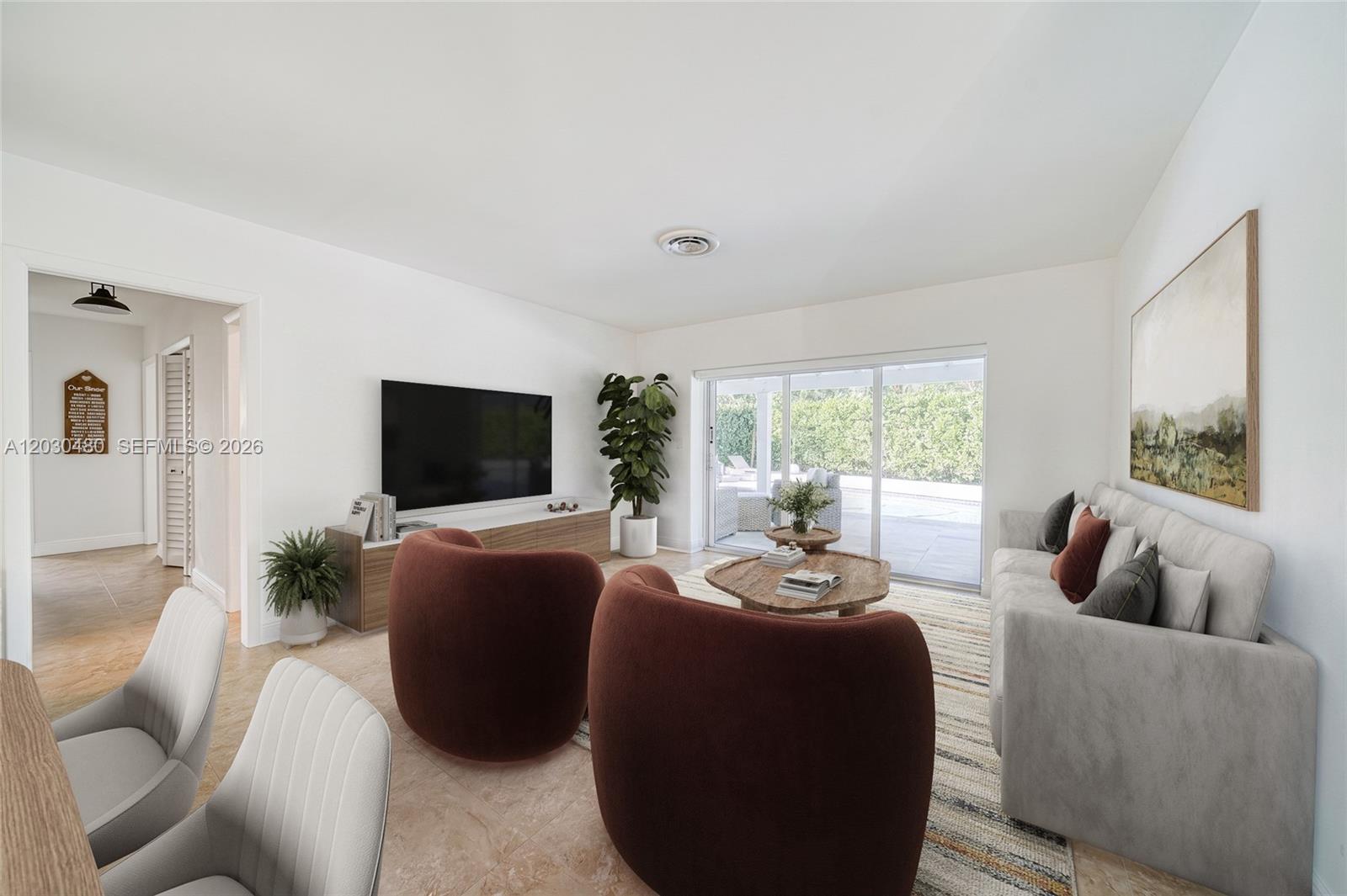 A living room features two rust-colored armchairs, a gray sofa, and a sliding glass door — 10600 SW 80th Ct, Miami FL 33156, MIAMI, FL