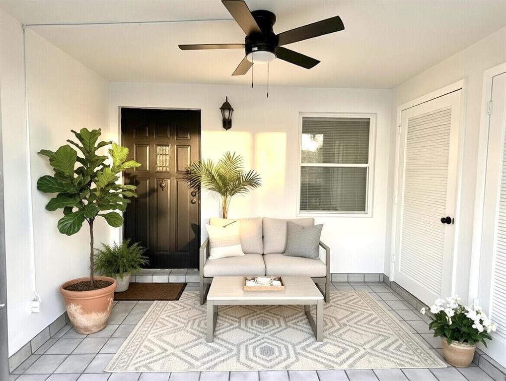 A covered patio features a black front door, a ceiling fan, and outdoor seating furniture — 3851 NW 84th Avenue # 1a, Sunrise FL 33351, SUNRISE, FL