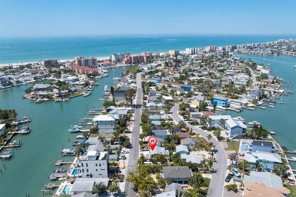 An aerial view shows a waterfront neighborhood with a red location pin on a house — 358 BOCA CIEGA DRIVE, MADEIRA BEACH, FL