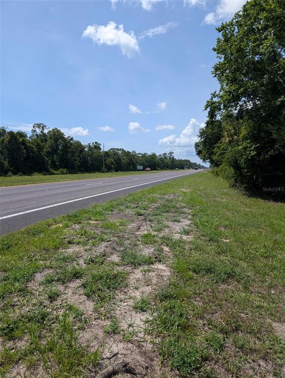 A view of a paved highway bordered by grass and trees under a blue sky — 5251 N US 19 HIGHWAY, CRYSTAL RIVER, FL