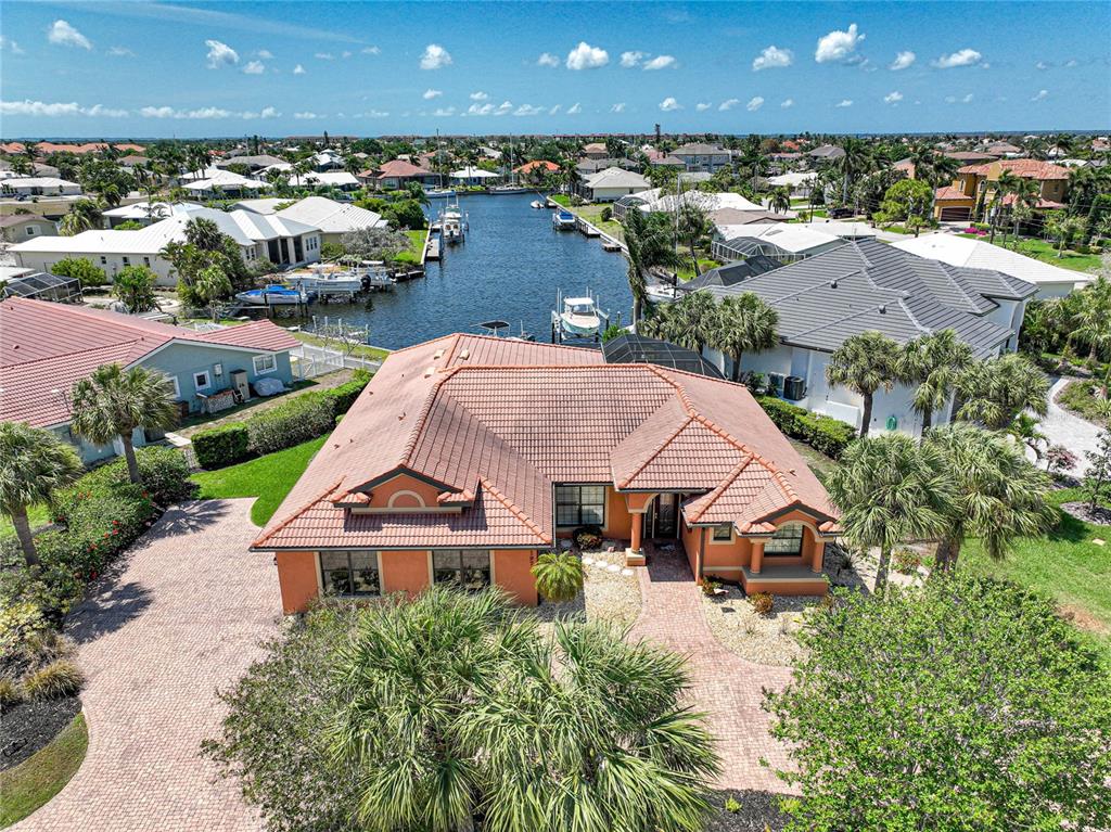 An aerial view of a single-story house with a tile roof and a canal — 197 GULFVIEW ROAD, PUNTA GORDA, FL