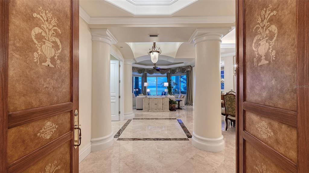 A foyer with marble floors and two large columns leads to a living room area — 4127 GULF OF MEXICO DRIVE UNIT N102, LONGBOAT KEY, FL