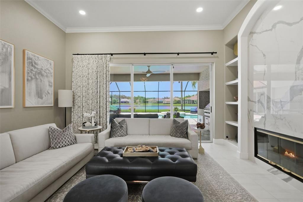 A foyer features a black double front door with decorative glass panels and two mirrors — 4618 AVENUE LONGCHAMPS, LUTZ, FL
