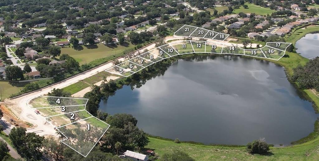This aerial rendering shows a residential development site with numbered lots bordering a large lake — 146 TRANQUIL MIRROR LAKE COURT Lot 19, CLERMONT, FL