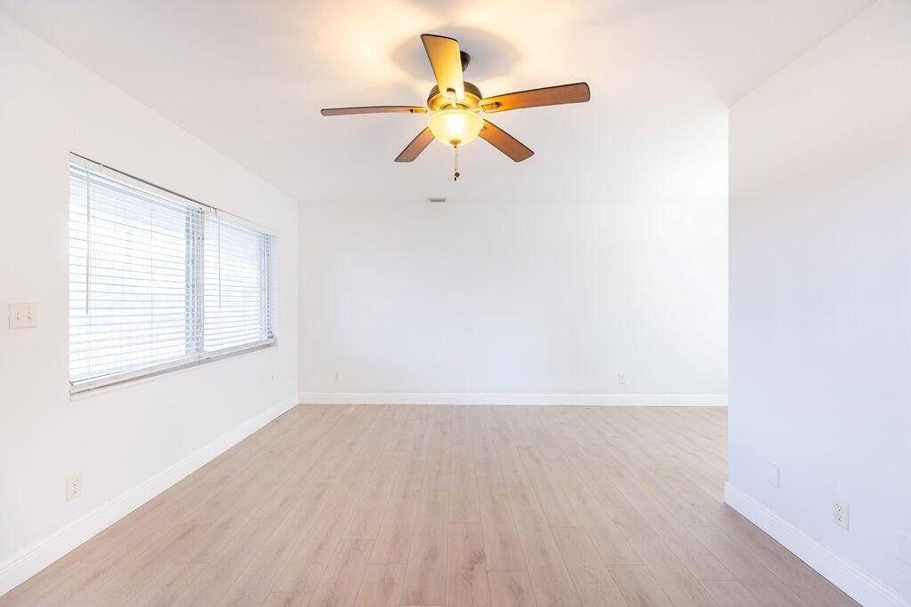 An empty room with white walls, light wood-look flooring, and a ceiling fan — 426 NE 7th Avenue # 2b, Delray Beach FL 33483, DELRAY BEACH, FL