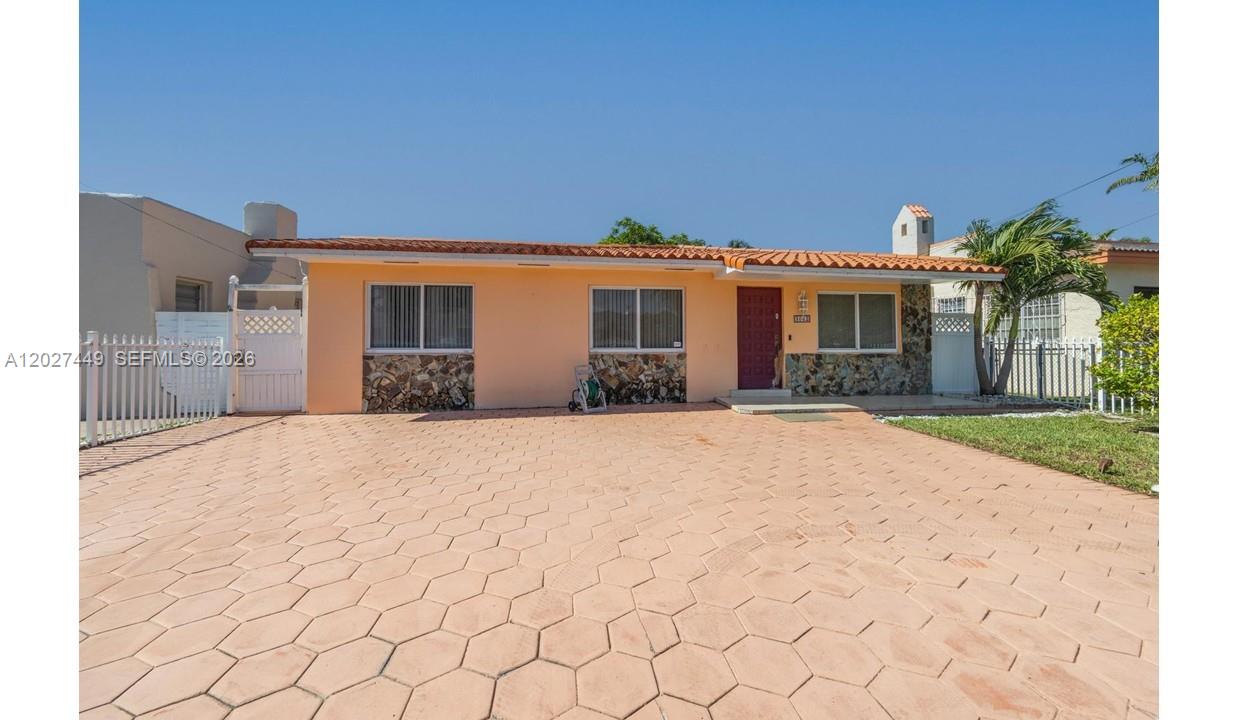 A single-story house with a peach-colored exterior, stone accents, and a paved hexagonal driveway — 3062 SW 14th St, Miami FL 33145, MIAMI, FL