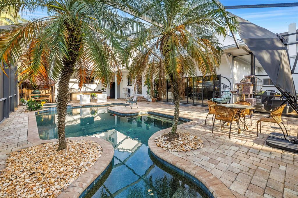 This aerial view shows a residential property with a large lawn, fountain, and swimming pool — 208 N SPRING BOULEVARD, TARPON SPRINGS, FL