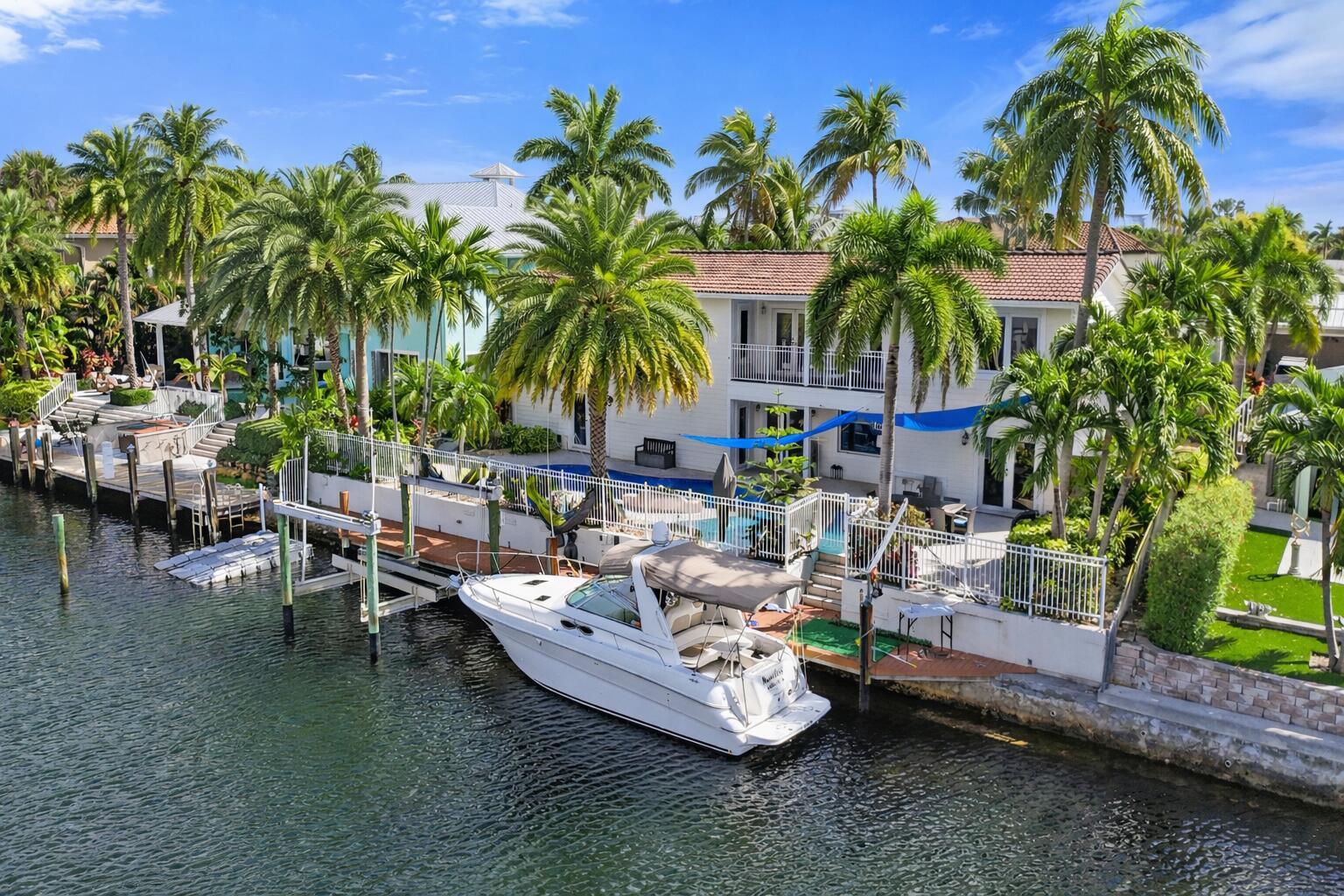 An aerial view shows a house with a brown roof, palm trees, and a driveway — 4011 NE 26th Avenue, Lighthouse Point FL 33064, LIGHTHOUSE POINT, FL