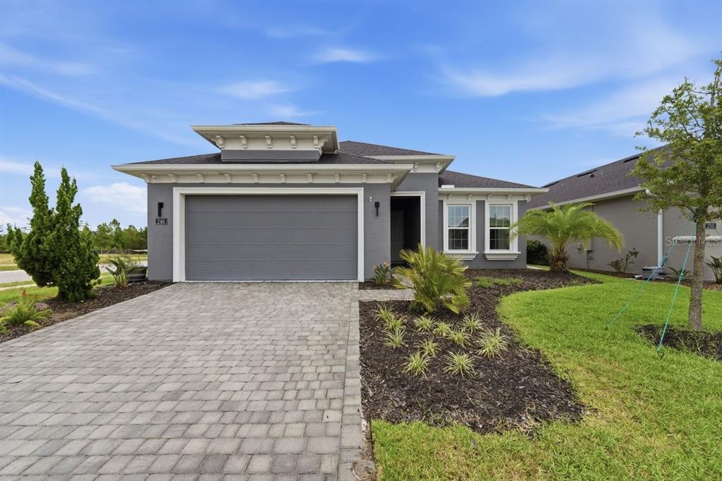 A gray single-story house with a two-car garage and a paved driveway — 246 AZURE MIST WAY, DAYTONA BEACH, FL