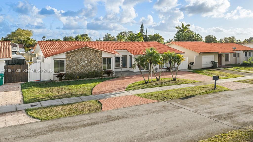 A single-story house with a red tile roof and a stone facade exterior — 13170 SW 20th St, Miami FL 33175, MIAMI, FL