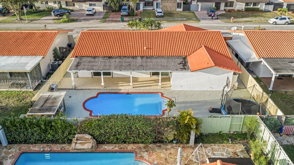 An aerial view shows a house with an orange tile roof and a backyard pool — 13170 SW 20th St, Miami FL 33175, MIAMI, FL