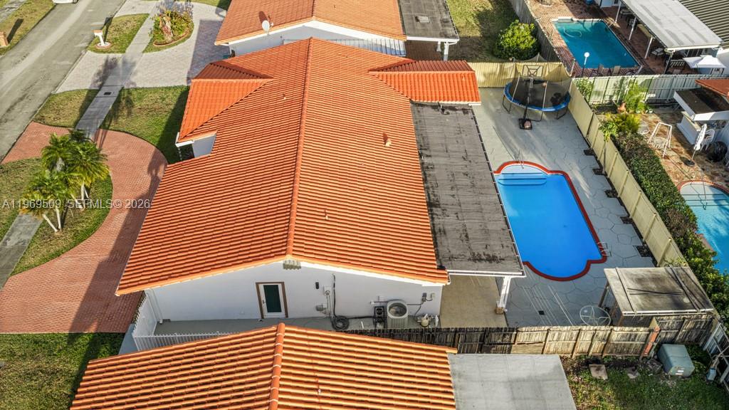 An aerial view shows a house with a red tile roof, pool, and fenced yard — 13170 SW 20th St, Miami FL 33175, MIAMI, FL