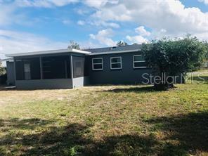 The exterior of a gray house features a screened-in porch and a large backyard — 44 S EDGEMON AVENUE, WINTER SPRINGS, FL
