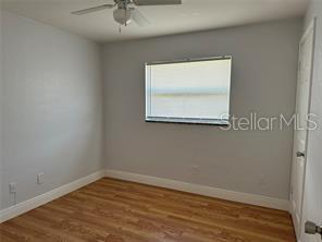 An empty bedroom features light gray walls, wood-look flooring, a ceiling fan, and a window — 44 S EDGEMON AVENUE, WINTER SPRINGS, FL