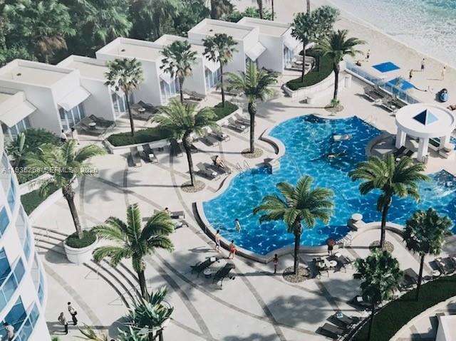 This is a rendering of a resort pool area with palm trees and beach access — 3101 S Ocean Dr # 606, Hollywood FL 33019, HOLLYWOOD, FL
