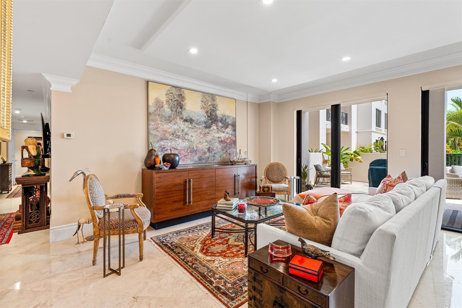 A living room features a large landscape painting, a patterned rug, and a white sofa — 200 E Palmetto Park Road # 404, Boca Raton FL 33432, BOCA RATON, FL