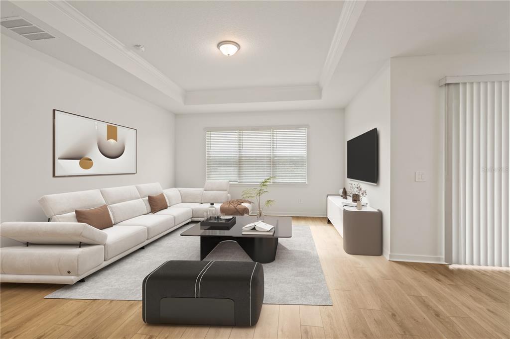 This digital rendering shows a modern living room with a sectional sofa and television — 11226 SYCAMORE GLEN LOOP, THONOTOSASSA, FL