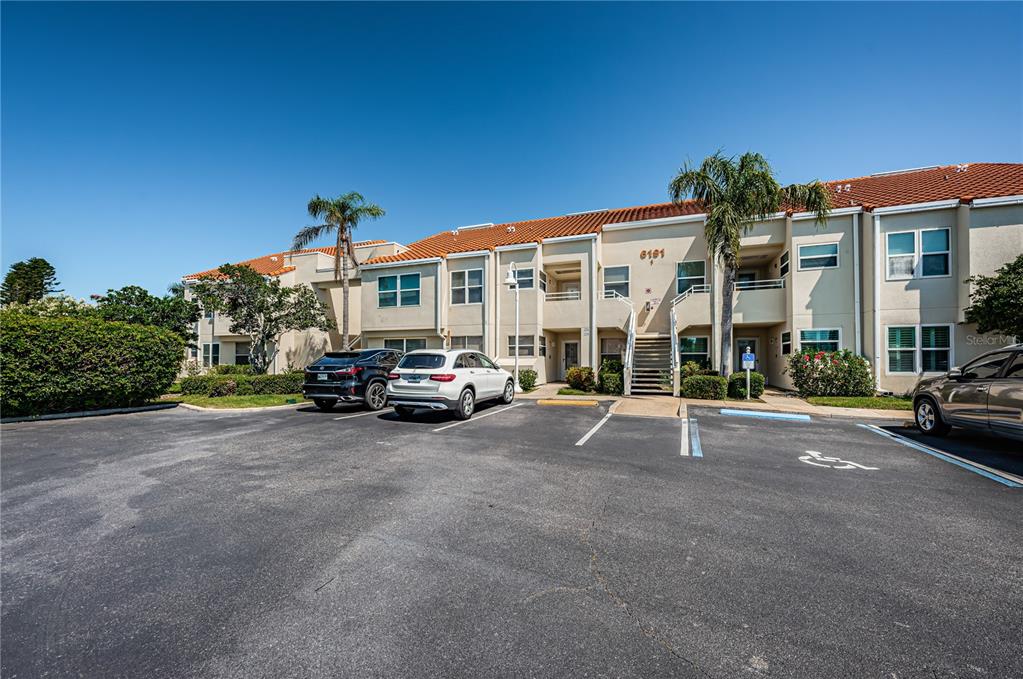 A two-story apartment building with a parking lot in the foreground — 6191 BAHIA DEL MAR BOULEVARD UNIT 103, ST PETERSBURG, FL