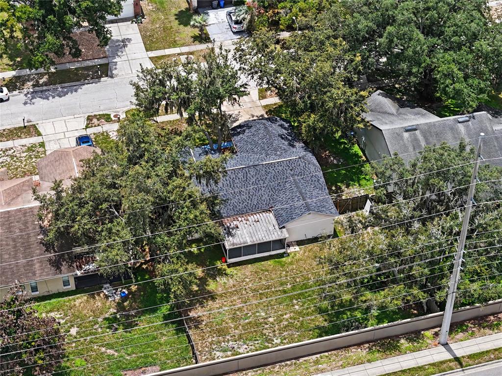 An aerial view shows a house with a shingled roof and a screened-in back porch — 12108 FRUITWOOD DRIVE, RIVERVIEW, FL