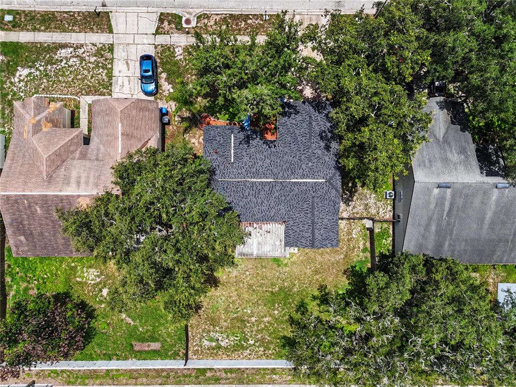 An aerial view shows a house with a dark shingled roof and a backyard — 12108 FRUITWOOD DRIVE, RIVERVIEW, FL