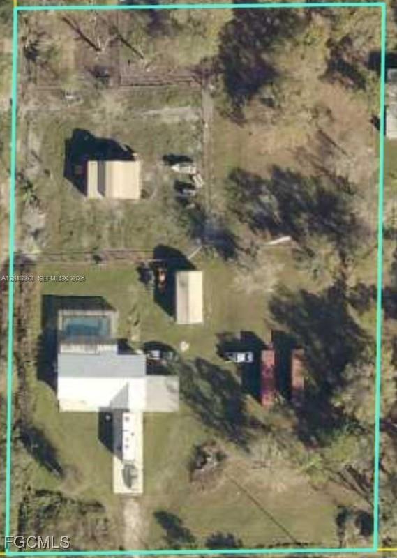 This aerial view shows a residential property with a house, pool, and several outbuildings — 826 B Rd., La Belle FL 33935, LA BELLE, FL
