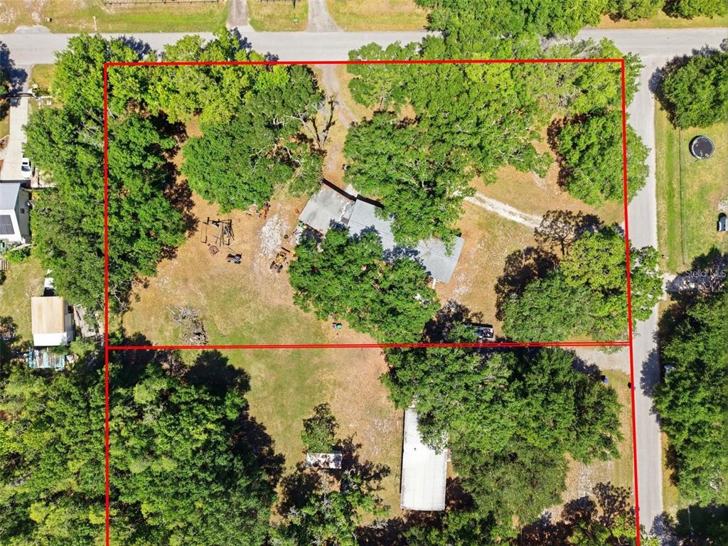 An aerial view shows two adjacent residential lots with trees, driveways, and two mobile homes — 17214 CHINABERRY ROAD, LUTZ, FL