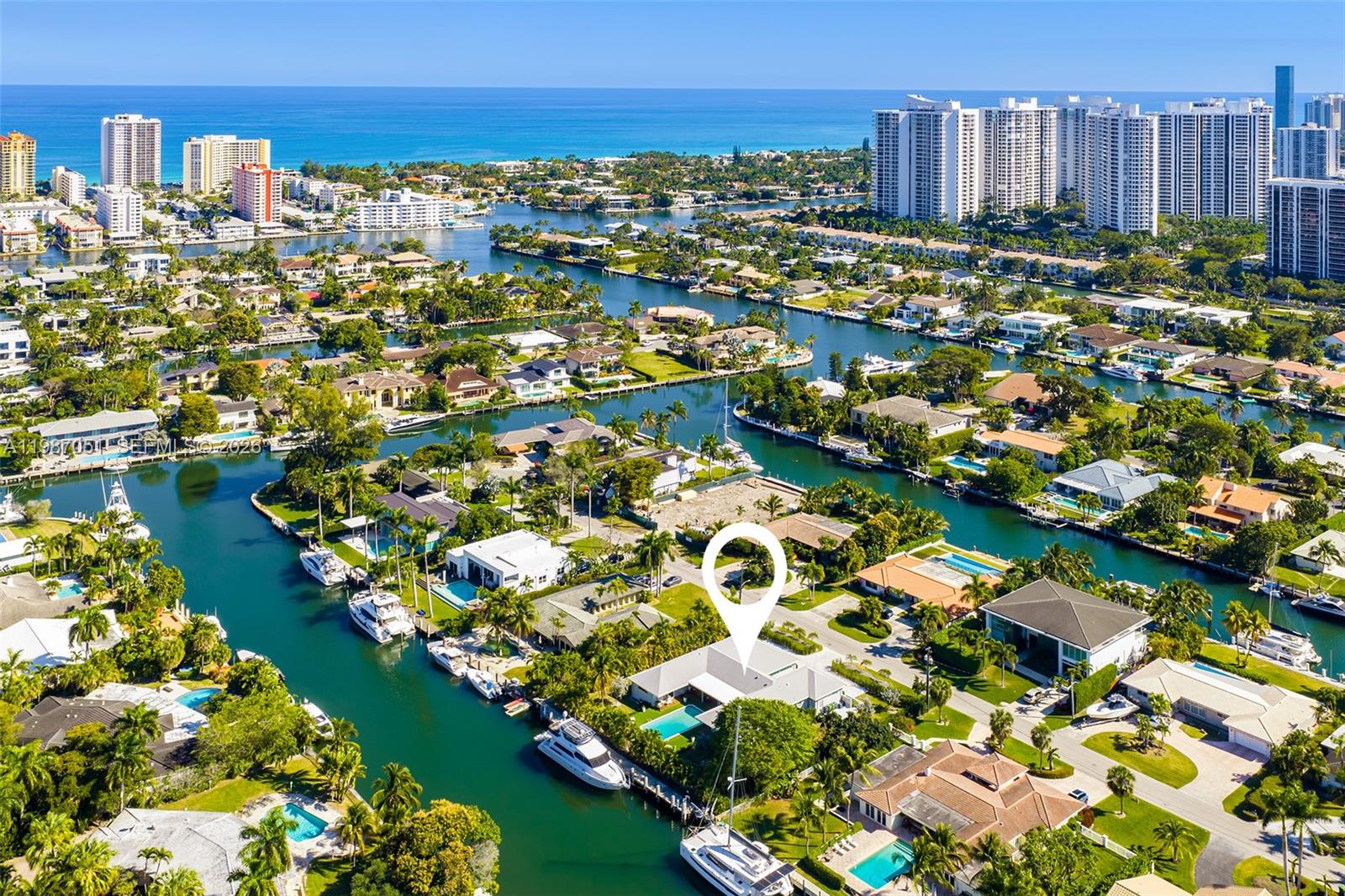 An aerial view shows a waterfront house with a pool and boat dock — 424 Alamanda Dr, Hallandale Beach FL 33009, HALLANDALE BEACH, FL