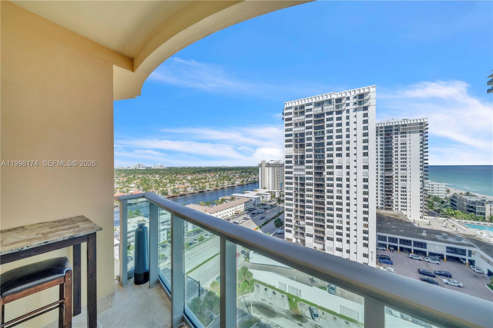 A high-rise balcony overlooks a coastal city, a waterway, and nearby apartment buildings — 2501 S Ocean Dr, Hollywood FL 33019, HOLLYWOOD, FL