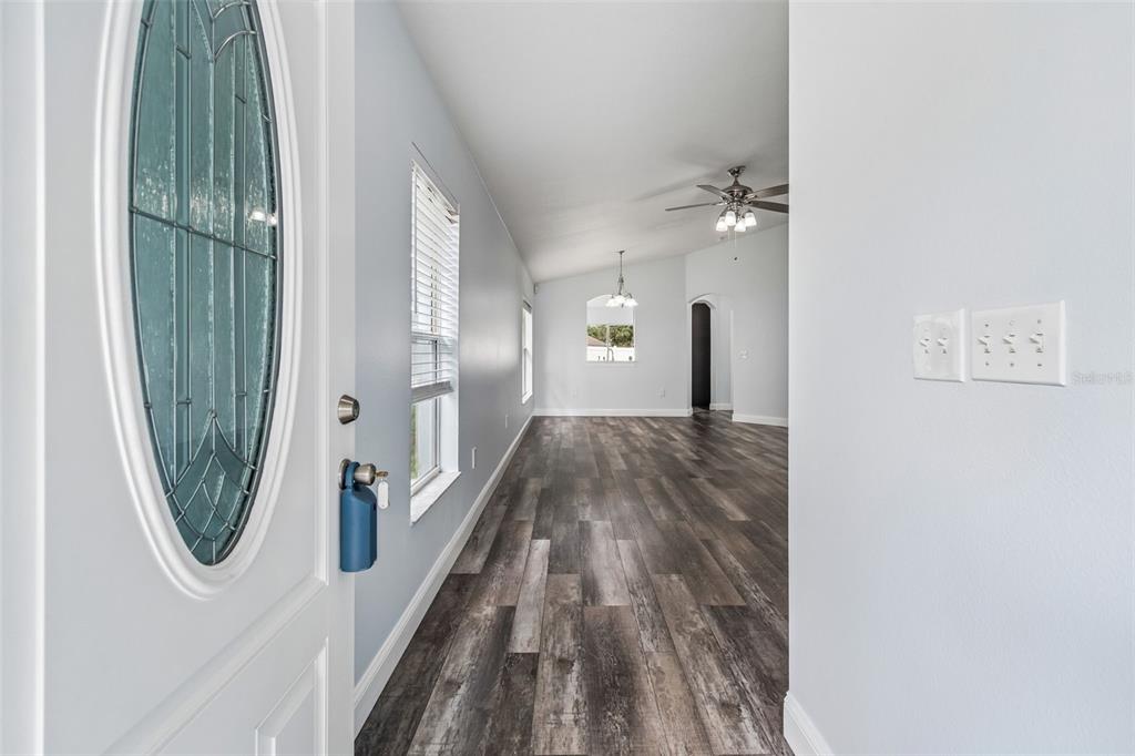 A concrete walkway leads to the front entrance of a light blue house — 10226 PERTHSHIRE CIRCLE, LAND O LAKES, FL