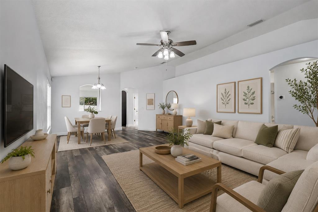 A view from an open front door into a hallway with wood-look flooring — 10226 PERTHSHIRE CIRCLE, LAND O LAKES, FL