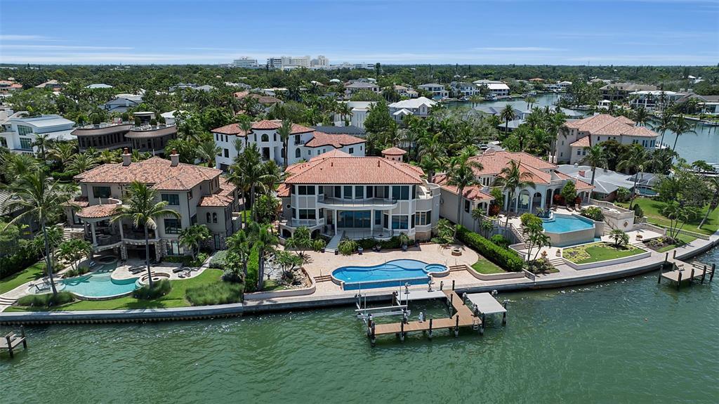 A curved stone staircase with a balustrade leads to arched wooden double front doors — 1372 HARBOR DRIVE, SARASOTA, FL