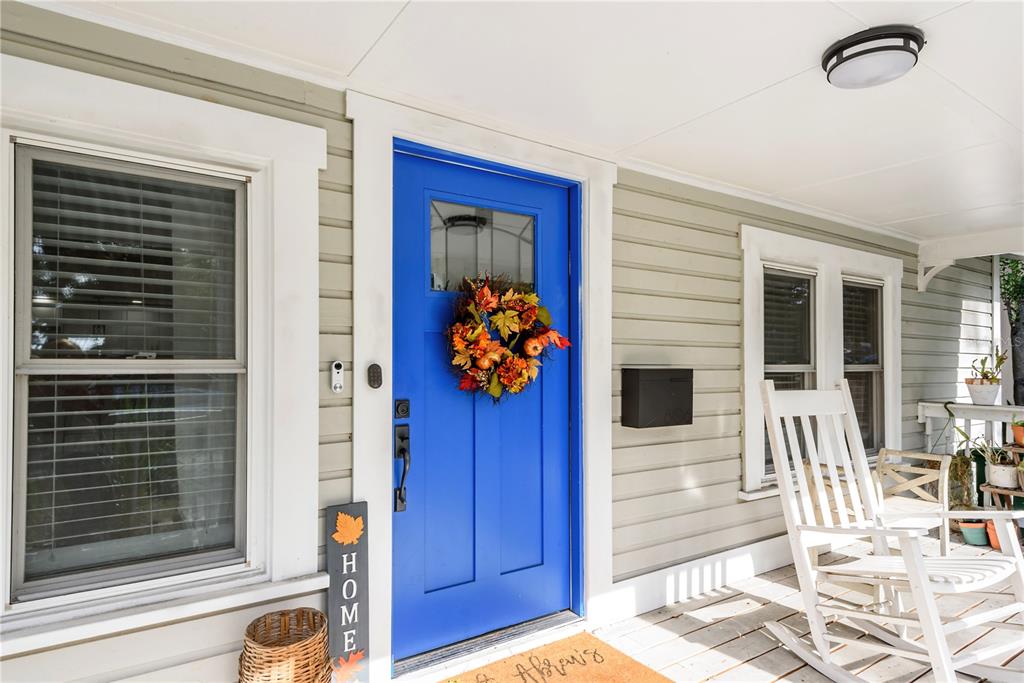 A bright blue front door with a fall wreath sits on a covered porch — 806 E HAMILTON AVENUE, TAMPA, FL