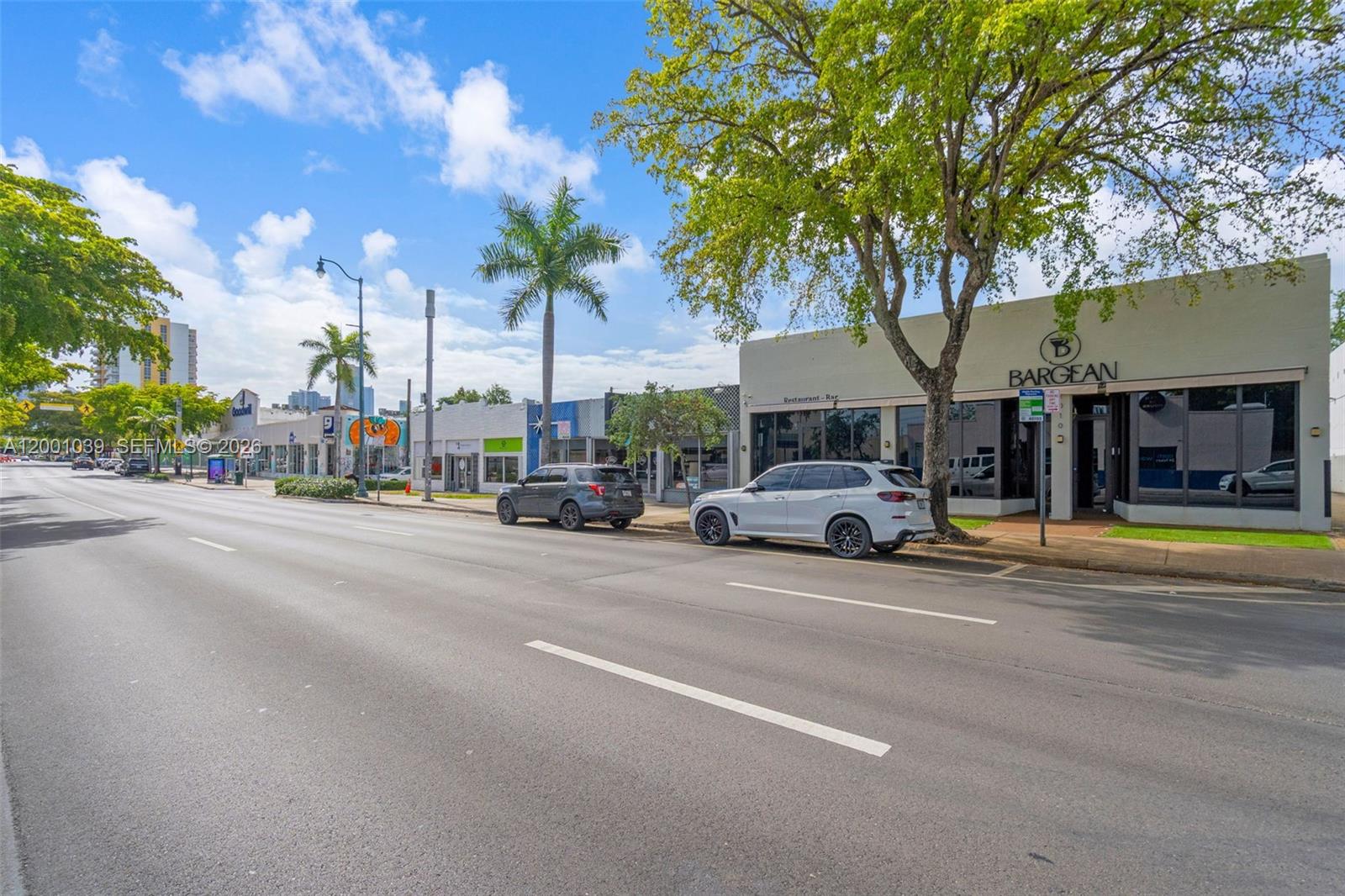 A street-level view shows a row of commercial buildings with parked cars and palm trees — 1000 SW 8th St, Miami FL 33130, MIAMI, FL