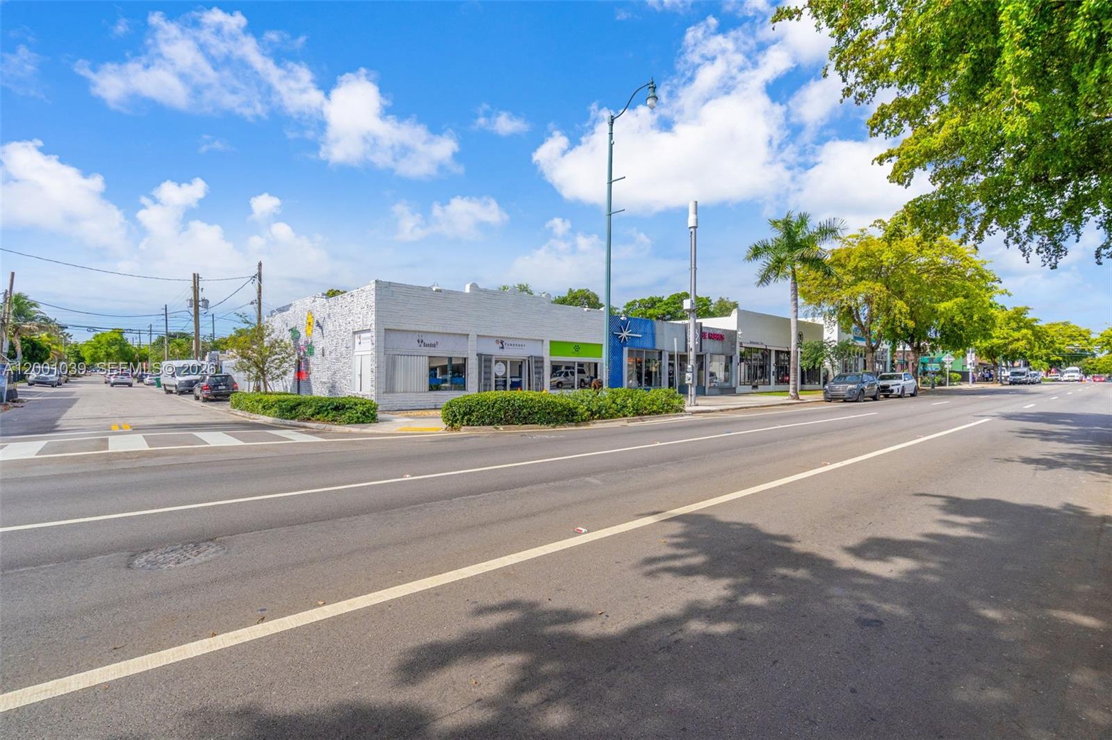 A street-level view shows a row of commercial storefronts with a palm tree and sidewalk — 1000 SW 8th St, Miami FL 33130, MIAMI, FL