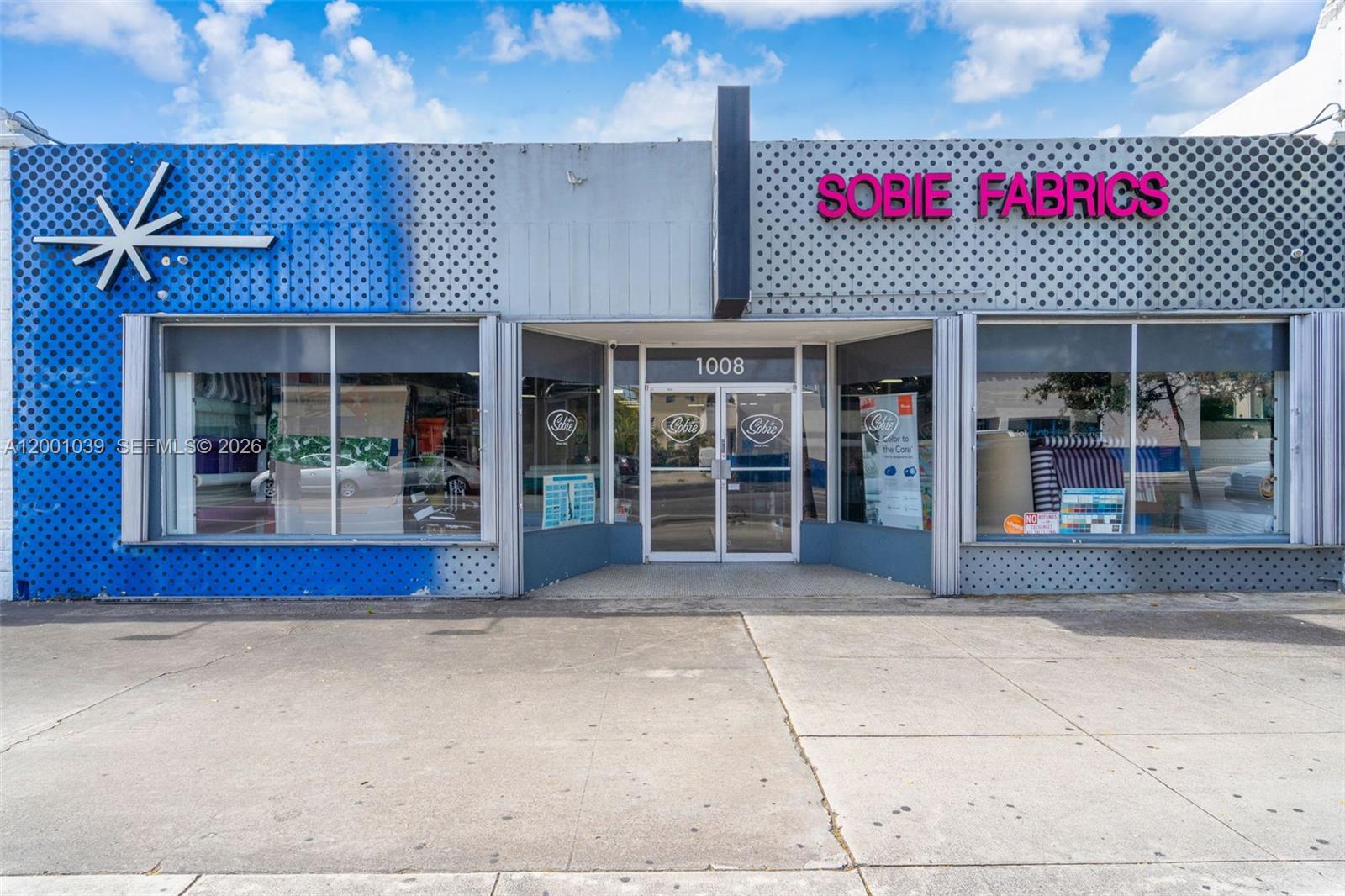 The exterior of a commercial building features a blue and gray polka-dot facade — 1000 SW 8th St, Miami FL 33130, MIAMI, FL