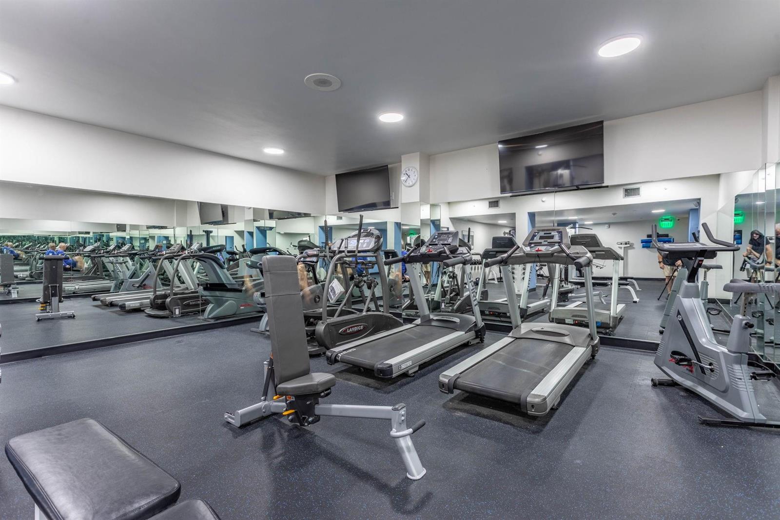 A gym features multiple treadmills, a weight bench, and large wall mirrors — 1620 S Ocean Boulevard # 7K, Pompano Beach FL 33062, POMPANO BEACH, FL