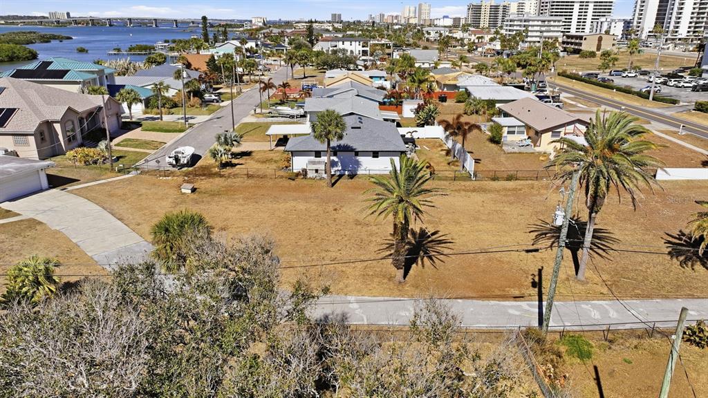 An aerial view shows a vacant residential lot with palm trees near a coastal neighborhood — 3816 CARDINAL BOULEVARD, PORT ORANGE, FL