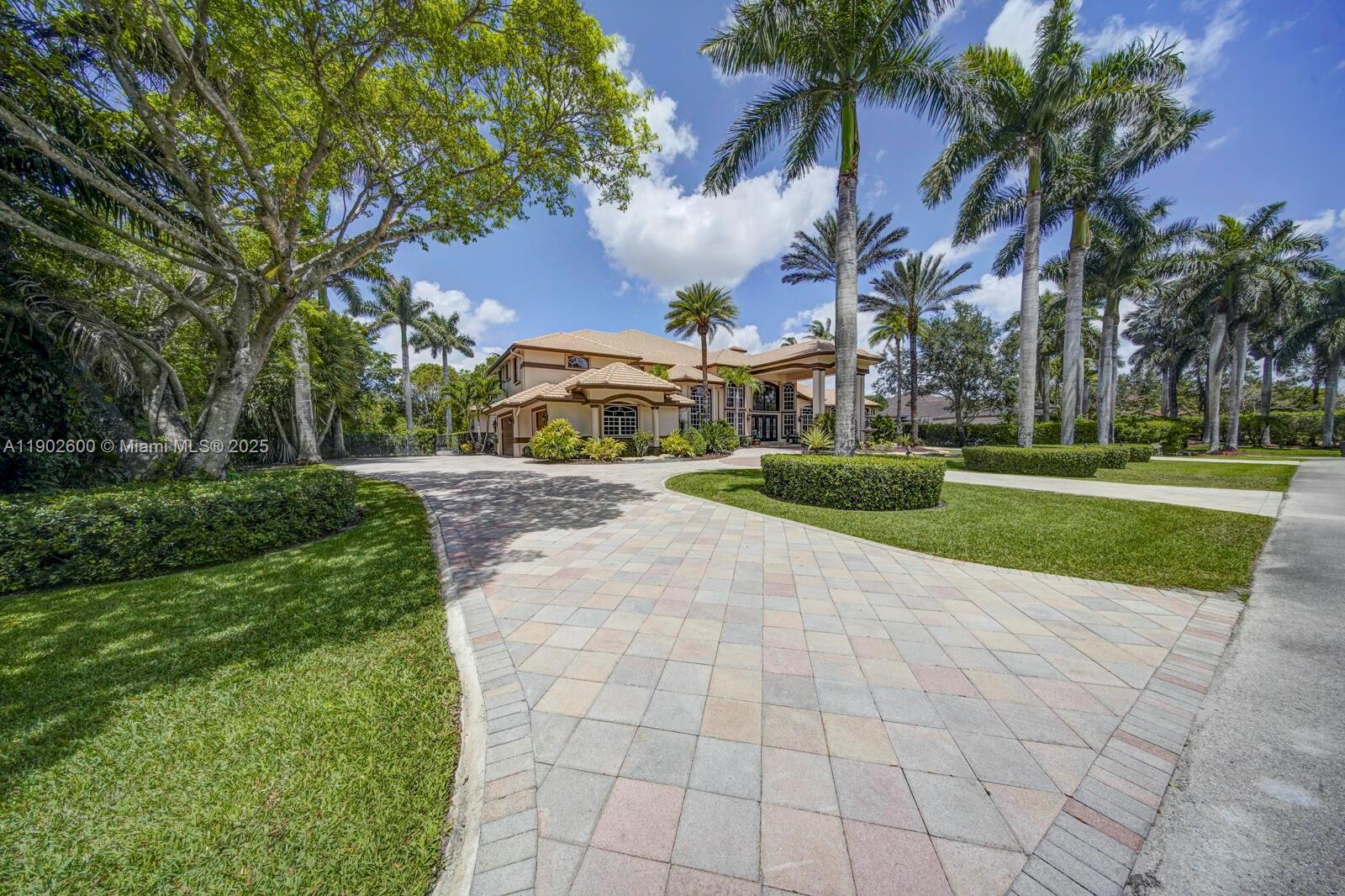 A large two-story house with a paved driveway and palm trees in the front yard — 3828 Pine Lake Dr, Weston FL 33332, WESTON, FL