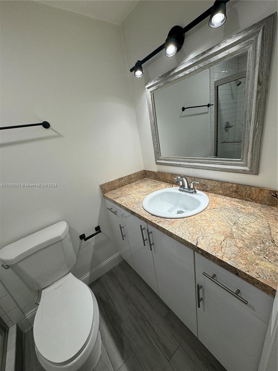 A bathroom features a white vanity with a granite countertop, a mirror, and a toilet — 2050 SW 122nd Ave # 22, Miami FL 33175, MIAMI, FL