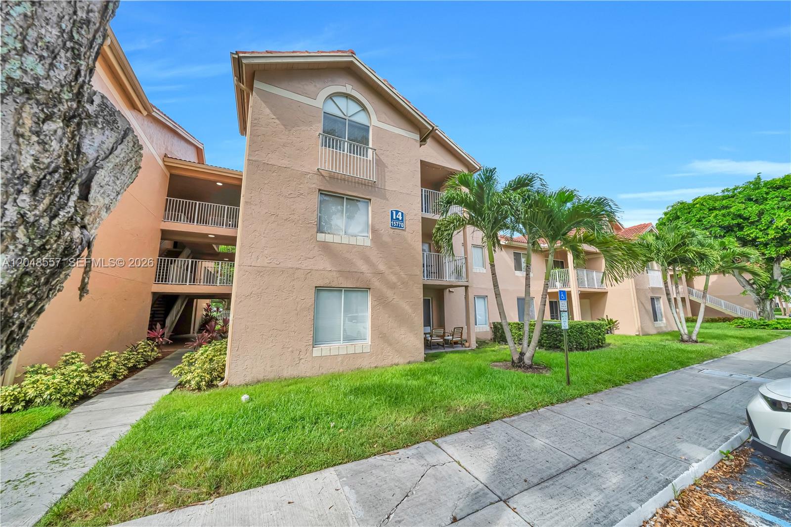 An exterior view shows a blue apartment door, a concrete staircase, and a covered walkway — 15770 SW 106th Ter # 106, Miami FL 33196, MIAMI, FL