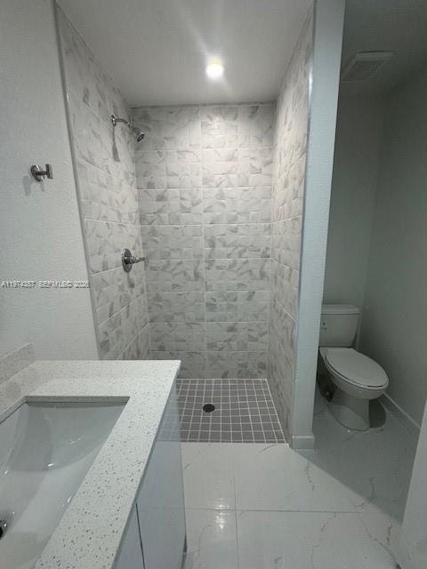 A bathroom features a walk-in shower with textured tile, a vanity, and a white toilet — 3131 NW 60 St. # 0, Miami FL 33142, MIAMI, FL