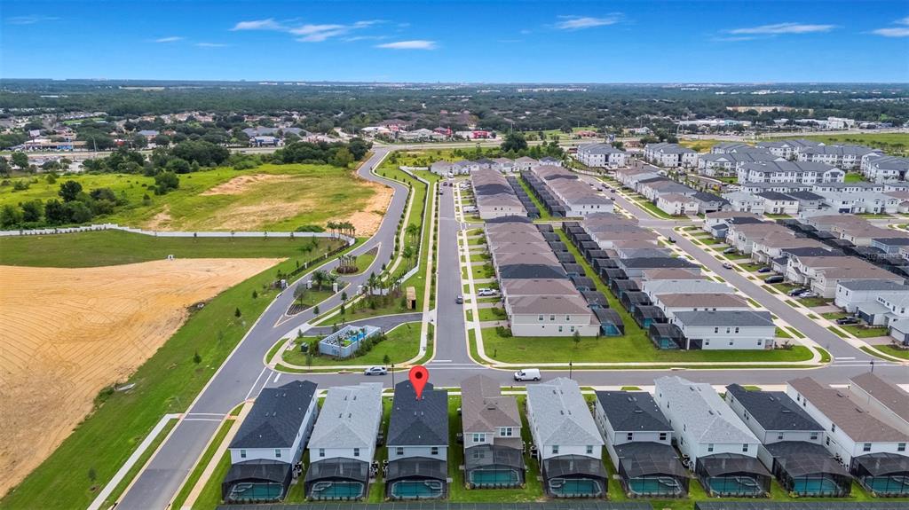 An aerial view shows a row of suburban houses with screened-in pools and backyards — 1293 EMERALD ROW STREET, CLERMONT, FL