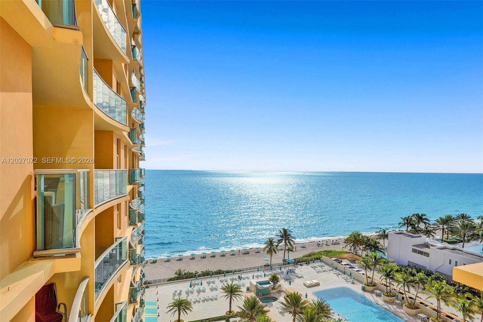 An exterior view from a high-rise balcony overlooking a beach, ocean, and swimming pool — 2501 S Ocean Dr, Hollywood FL 33019, HOLLYWOOD, FL