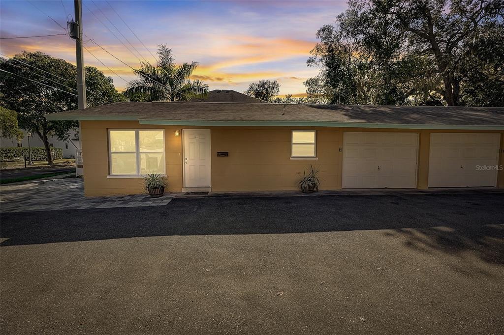 A single-story tan building with a white front door and two attached garage bays — 626 S OSPREY AVENUE, SARASOTA, FL
