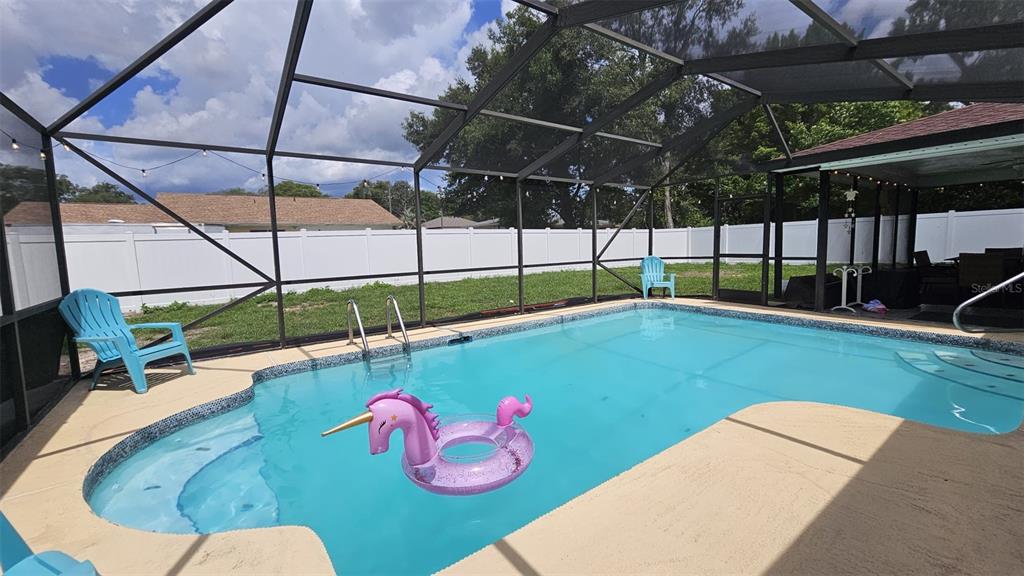 A single-story house with a white exterior, dark garage door, and a concrete driveway — 729 SINCLAIR TERRACE, INVERNESS, FL