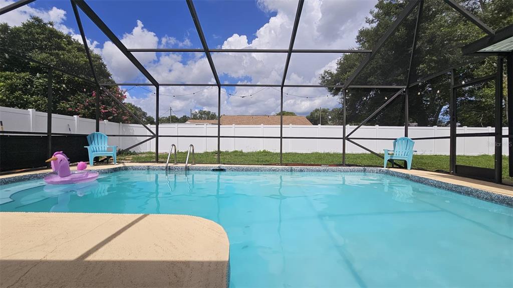 A single-story house with a two-car garage, light-colored stucco exterior, and a brown roof — 729 SINCLAIR TERRACE, INVERNESS, FL
