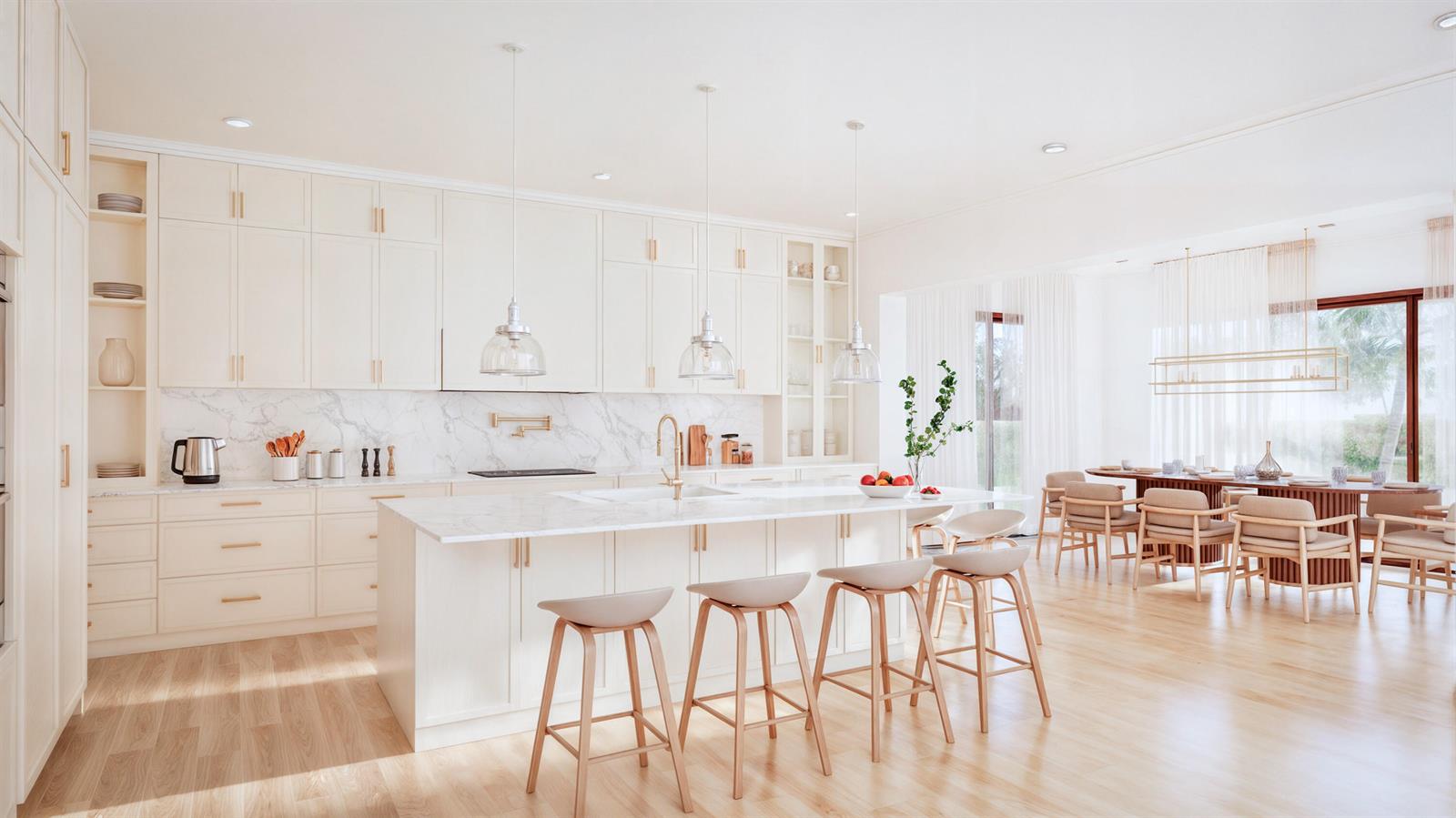 A bright, modern kitchen features white cabinetry, marble countertops, and a large island with stools — 1230 Aryana Way, Delray Beach FL 33445, DELRAY BEACH, FL