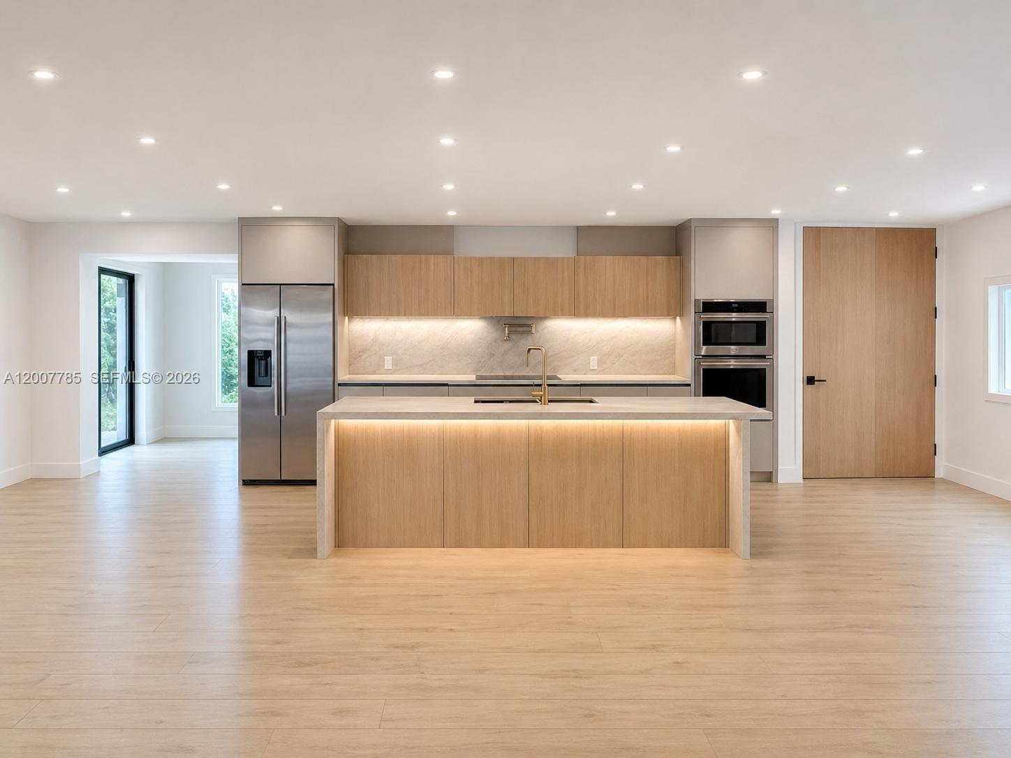 A modern kitchen features light wood cabinetry, a central island, and stainless steel appliances — 12810 SW 18th St, Miami FL 33175, MIAMI, FL