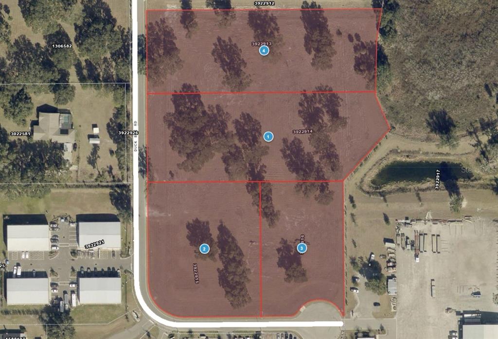 This aerial map shows four adjacent parcels of land outlined in red — 1080 DUCK BOX ROAD, UMATILLA, FL